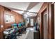 Home office with wood paneled walls, desks, and a view into the kitchen at 6222 Brentwood Ave, Sarasota, FL 34231