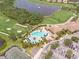 Pool area and clubhouse near golf course and lake at 6705 Grand Estuary Trl # 201, Bradenton, FL 34212