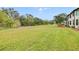 Large grassy backyard with mature trees at 6705 Grand Estuary Trl # 201, Bradenton, FL 34212