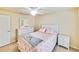 Bright bedroom with a queen-size bed, dresser, and ceiling fan at 6705 Grand Estuary Trl # 201, Bradenton, FL 34212