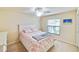 Bright bedroom with coral bedding and built-in storage at 6705 Grand Estuary Trl # 201, Bradenton, FL 34212