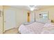 Guest bedroom with a queen-size bed and a view of the hallway at 6705 Grand Estuary Trl # 201, Bradenton, FL 34212