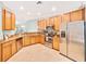 Bright kitchen featuring stainless steel appliances and wood cabinets at 6705 Grand Estuary Trl # 201, Bradenton, FL 34212