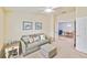 Comfortable living area with sofa, ottoman, and view to dining area at 6705 Grand Estuary Trl # 201, Bradenton, FL 34212