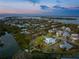 Aerial view of house nestled in a neighborhood near the water at 6821 Longboat S Dr, Longboat Key, FL 34228