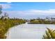 Aerial view of waterfront homes with lush landscaping and private docks at 6821 Longboat S Dr, Longboat Key, FL 34228