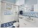 Clean bathroom with shower/tub combo and fun tile design at 6821 Longboat S Dr, Longboat Key, FL 34228