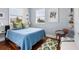 Charming bedroom with hardwood floors and blue bedding at 6821 Longboat S Dr, Longboat Key, FL 34228