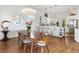 Modern dining area with wood table and white chairs at 6821 Longboat S Dr, Longboat Key, FL 34228