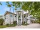 Charming waterfront home with lush landscaping and a spacious front porch at 6821 Longboat S Dr, Longboat Key, FL 34228