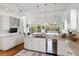 Bright kitchen featuring white cabinets, stainless steel appliances, and hardwood floors at 6821 Longboat S Dr, Longboat Key, FL 34228