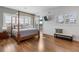 Main bedroom with hardwood floors and a four-poster bed at 6821 Longboat S Dr, Longboat Key, FL 34228