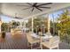 Spacious covered porch with outdoor seating and ceiling fans at 6821 Longboat S Dr, Longboat Key, FL 34228