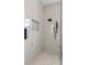 Modern shower with marble tile and rainfall shower head at 6821 Longboat S Dr, Longboat Key, FL 34228