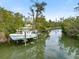 Boat lift on private dock providing direct waterfront access at 6821 Longboat S Dr, Longboat Key, FL 34228