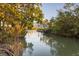 Scenic waterfront view with tranquil canal and lush vegetation at 6821 Longboat S Dr, Longboat Key, FL 34228