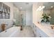 Elegant bathroom with double vanity, soaking tub, and walk-in shower at 719 Maldives Trl, Sarasota, FL 34234