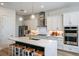 Modern kitchen with white cabinets, quartz counters and island at 719 Maldives Trl, Sarasota, FL 34234