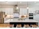 Modern kitchen with white cabinets, stainless steel appliances and large island at 719 Maldives Trl, Sarasota, FL 34234