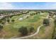 Aerial view of golf course community with mature trees and ponds at 7204 Annanhill Ln, Lakewood Ranch, FL 34202