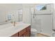 Clean bathroom with a walk-in shower and wood vanity at 7204 Annanhill Ln, Lakewood Ranch, FL 34202