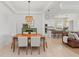 Bright dining room with light wood table and seating for six at 7204 Annanhill Ln, Lakewood Ranch, FL 34202