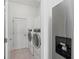 Convenient laundry room with washer, dryer, and extra storage at 7204 Annanhill Ln, Lakewood Ranch, FL 34202