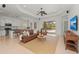 Open living room with view of pool and sliding glass doors at 7204 Annanhill Ln, Lakewood Ranch, FL 34202