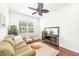 Bright living room featuring a green sofa and two armchairs at 7204 Annanhill Ln, Lakewood Ranch, FL 34202