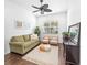 Bright living room featuring a green sofa and two armchairs at 7204 Annanhill Ln, Lakewood Ranch, FL 34202