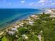 Aerial view of waterfront homes and coastline with lush vegetation at 7314 Point Of Rocks Rd, Sarasota, FL 34242