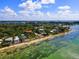 Expansive aerial view of waterfront homes and lush landscaping at 7314 Point Of Rocks Rd, Sarasota, FL 34242