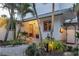 Inviting home entrance with a charming porch and tropical landscaping at 7314 Point Of Rocks Rd, Sarasota, FL 34242