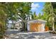 Charming waterfront home with a light-colored exterior and wooden garage door at 7314 Point Of Rocks Rd, Sarasota, FL 34242