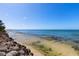 Rocky shoreline and calm ocean view on a sunny day at 7314 Point Of Rocks Rd, Sarasota, FL 34242