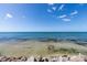 Calm ocean view with clear shallow water and rocky shoreline at 7314 Point Of Rocks Rd, Sarasota, FL 34242