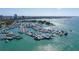 Expansive aerial view of a marina filled with many boats and yachts on a beautiful sunny day with blue water at 7324 Phillips St, Sarasota, FL 34243