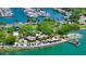 Tropical island escape with thatched-roof huts, palm trees, beach chairs, and crystal-clear turquoise water in marina at 7324 Phillips St, Sarasota, FL 34243