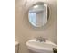 Close-up of pedestal sink and decorative mirror in half bath at 7324 Phillips St, Sarasota, FL 34243