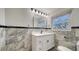 Beautiful bathroom with marble walls and black accents at 7324 Phillips St, Sarasota, FL 34243