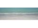 Calm waves gently rolling onto the sandy shore of the beach, creating a serene and peaceful ocean scene at 7324 Phillips St, Sarasota, FL 34243