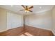 Spacious bedroom offers hardwood floors, neutral paint, ceiling fan and a large closet at 7324 Phillips St, Sarasota, FL 34243