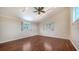 Bright bedroom with vaulted ceilings, ceiling fan, and hardwood floors at 7324 Phillips St, Sarasota, FL 34243