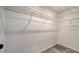 Walk-in closet is spacious with modern wire shelving and grey wood-look tile at 7324 Phillips St, Sarasota, FL 34243