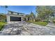 Paver driveway leading up to a contemporary home with a well-maintained lawn at 7324 Phillips St, Sarasota, FL 34243