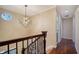 Upstairs hallway featuring wood floors, modern light fixture and decorative staircase at 7324 Phillips St, Sarasota, FL 34243