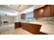 Kitchen featuring marble countertops, wood cabinets, stainless steel appliances, and breakfast bar at 7324 Phillips St, Sarasota, FL 34243