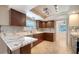 Kitchen area featuring marble countertops, wood cabinets, tile floors, and breakfast bar at 7324 Phillips St, Sarasota, FL 34243