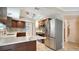 Kitchen featuring stainless steel appliances, marble backsplash, and dark wood cabinets at 7324 Phillips St, Sarasota, FL 34243