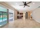 Spacious room featuring tile floors, kitchen, staircase, ceiling fan, and natural light at 7324 Phillips St, Sarasota, FL 34243